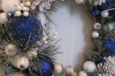 21 this royal blue and white wreath seems to be frozen and snowy