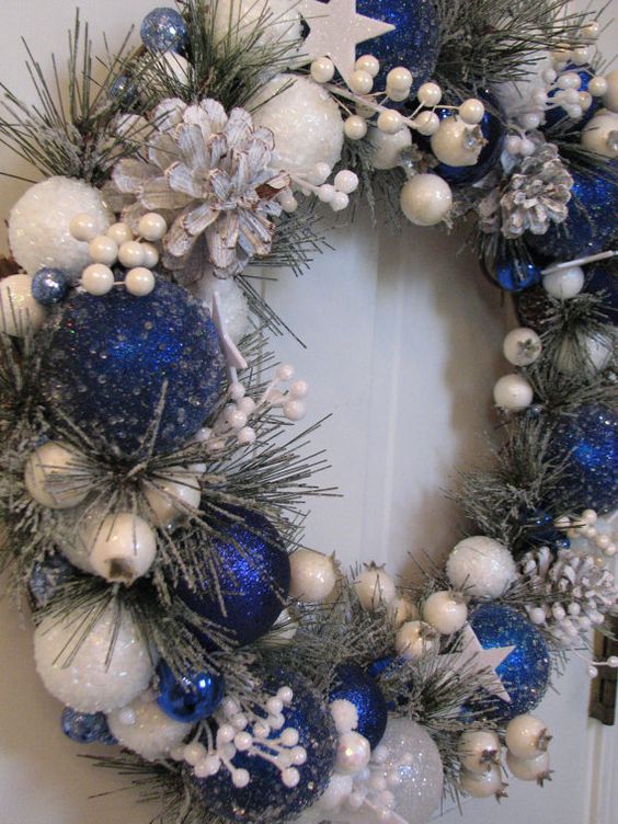 this royal blue and white wreath seems to be frozen and snowy