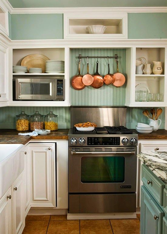 I love the look of copper pans opposite a green beadboard backsplash