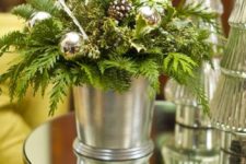 22 a bucket with evergreens, ornaments and pinecones