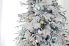 22 light green and matte gold ornaments look very fresh on a flocked tree