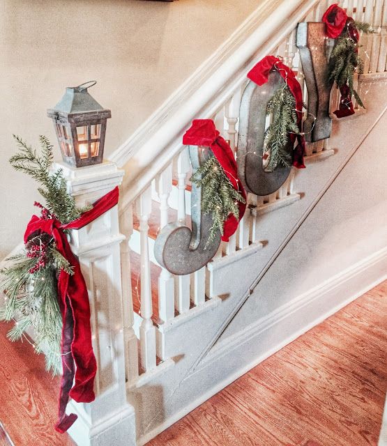 JOY letters decorated with red and hun on the stairs