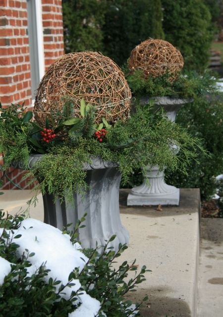 pots with greenery and grapevine balls