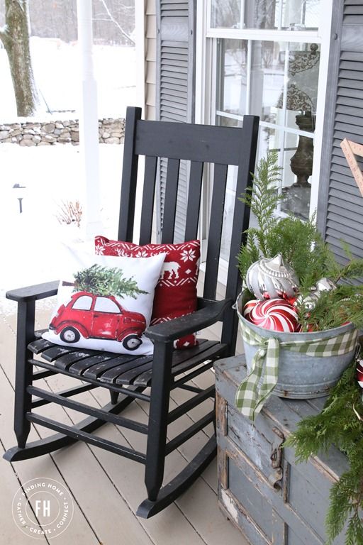 a rocker with pillows, a galvanized bathtub with evergreens and ornaments