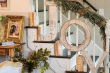 26 shabby wooden JOY letters attached to the banister and a foliage and burlap garland