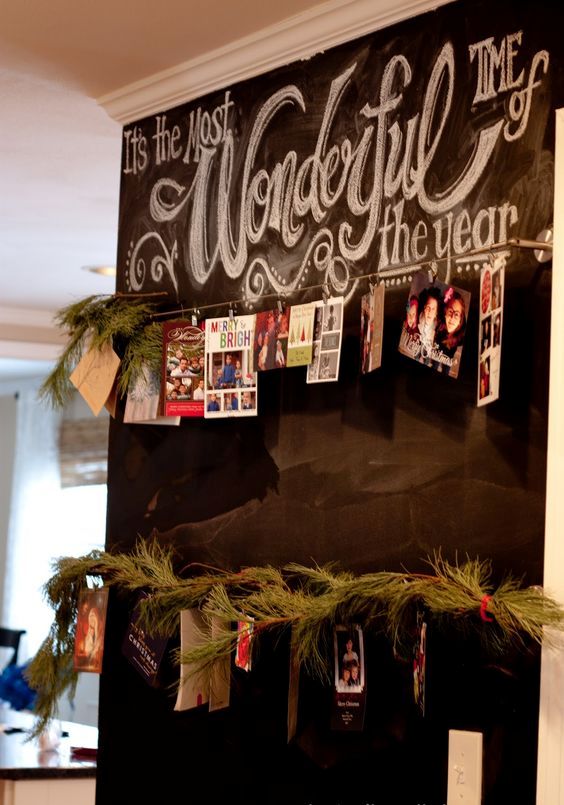 a chalkboard wall with wire and cards hanging on it