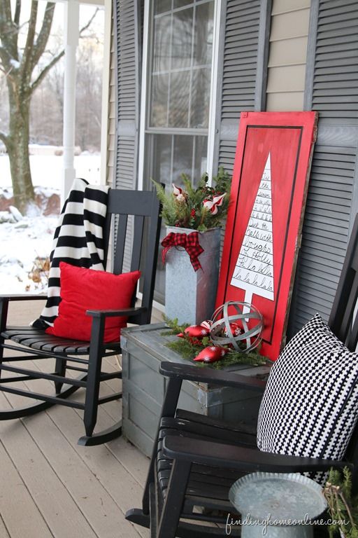 a couple of rockers, a wooden sign, ornaments and evergreens