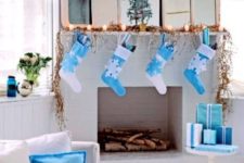 30 a crispy white and blue Christmas mantel, gifts, stockings and pillows