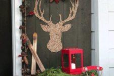 31 a rustic setup with a crate, a sleigh, a lantern and pinecone decor