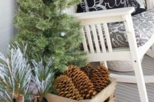 33 a white rocker, an industrial crate filled with pinecones, a fir tree