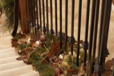 33 brown, green and gold garland placed on the staircase