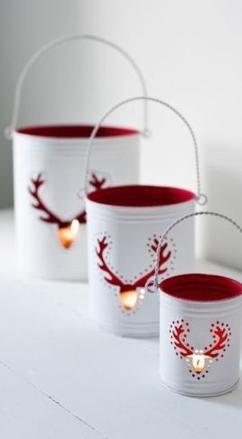 white tin can lanterns with red inner side and deer cutouts