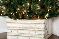 36 cover your tree base with a gift box for a glam look