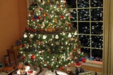 37 create a whole scene at the base of your tree to make the kids and adults happy