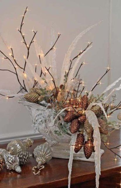sleigh filled with lighted twigs, pinecones, feathers and ornaments