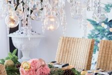 a lush holiday chandelier of evergreens, crystals and clear baubles is a cool solution for Christmas