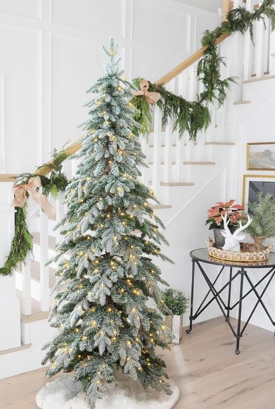 a simple and cool flocked Christmas tree with lights only is always a good idea for Christmas space decor