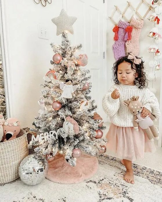 a small Christmas tree decorated with blush ornaments, angels and unicorns is a very cute idea for a little girl's room