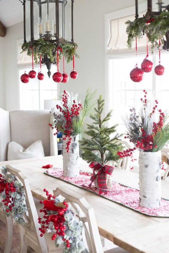 vintage lantern-styled chandelier with evergreens and red ornaments are amazing for classic holiday decor