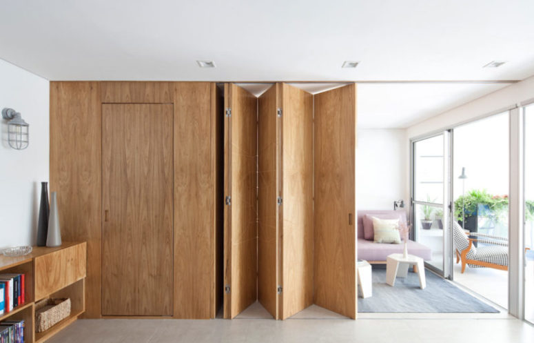 This modern flexible apartment was designed for a young couple, and a geo wooden panel was is a focal point here