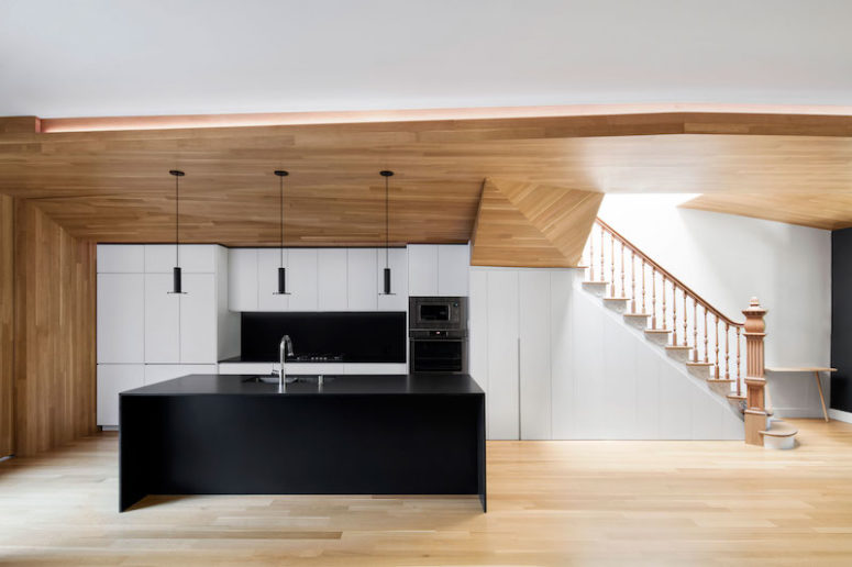 Black and white accents give the duplex a modern look, and lots of wood make it cozier and natural looking Black and white accents give the duplex a modern look, and lots of wood make it cozier and natural-looking