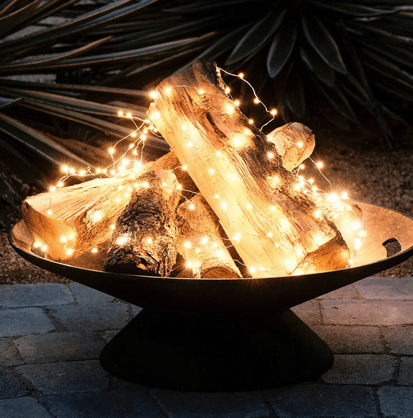 https://www.digsdigs.com/photos/2016/12/02-a-metal-bowl-with-firewood-and-string-lights-to-imitate-a-fire.png