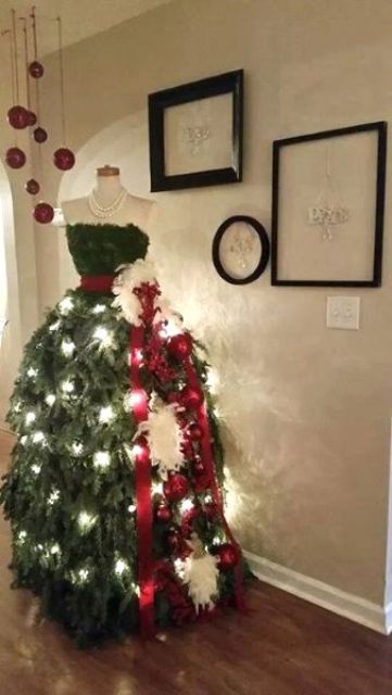 elegant dress Christmas tree with lights and a red sash