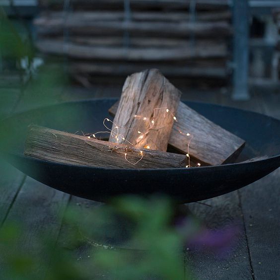 matte black bowl with some firewood and lights looks modern
