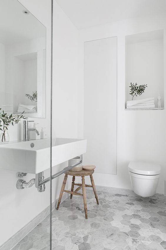 marble hexagon tiles spruce this simple bathroom a little bit