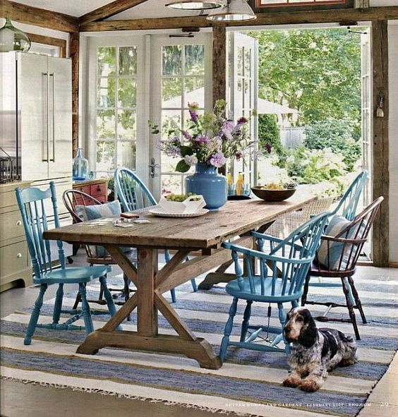place your wooden picnic table and mismatched chairs next to the doors to outdoors