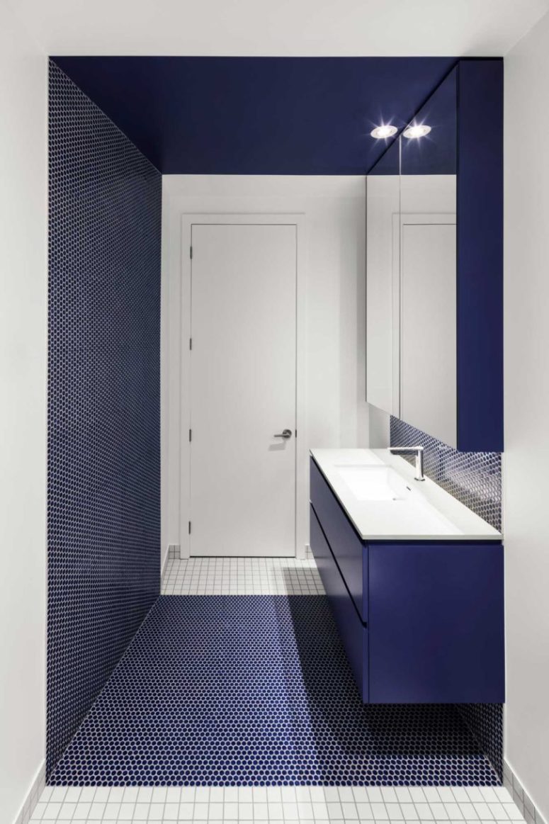 penny tiles in a bathroom Another bathroom features the same penny tiles in navy color, again mixed with crispy white tiles