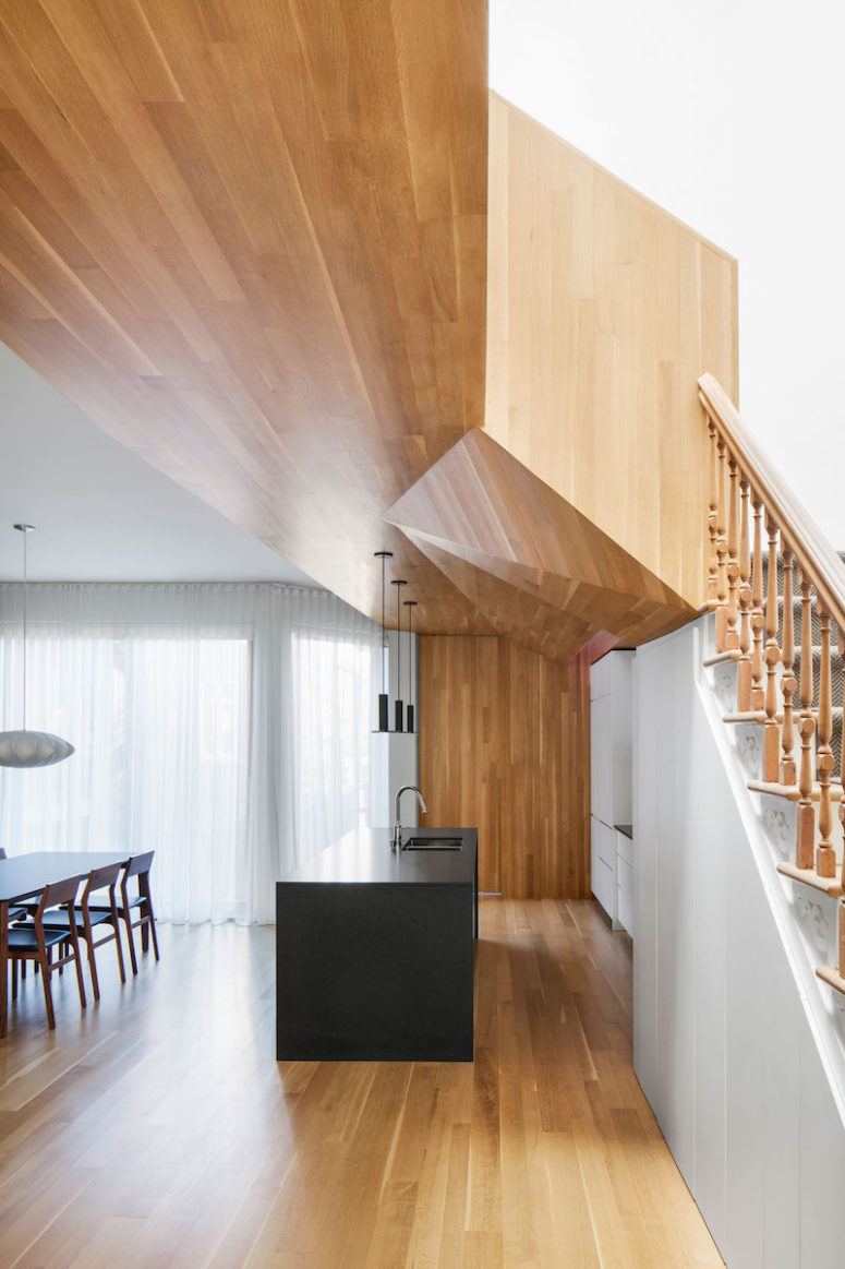 creative ceiling design The geometrical ceiling covered with warm woods is a focal point of the kitchen and dining area