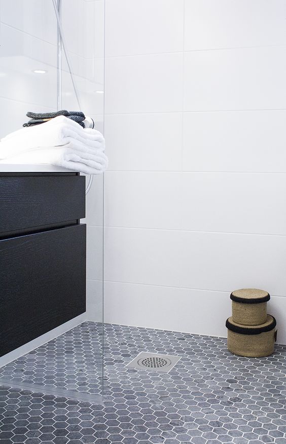 navy hex tiles in the shower on the floor