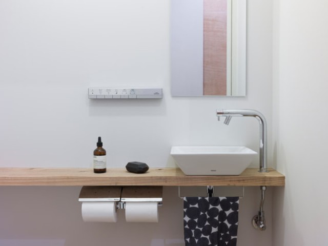 A wooden countertop and a small sink look cute together