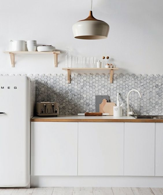 grey hex tile backsplash contrasts with white cabinets