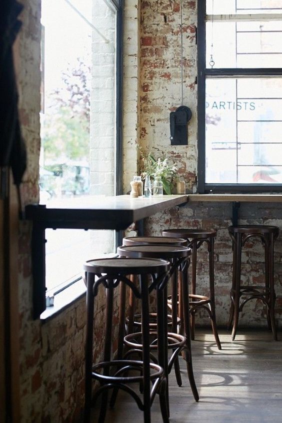 industrial shabby decor with rusty brick clad and wooden furniture