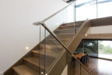 10 modern staircase with a glass balustrade and wooden handrails for a contrast