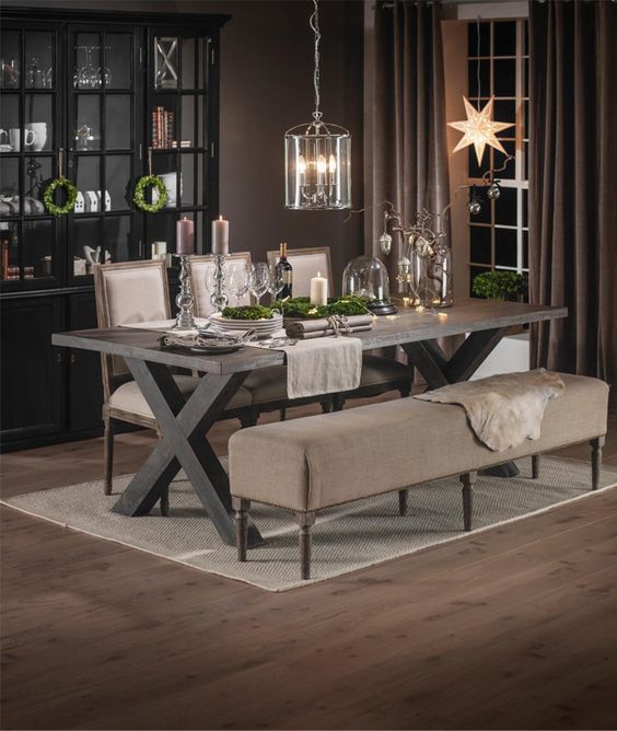rustic dark-stained table with comfy upholstered chairs and a bench