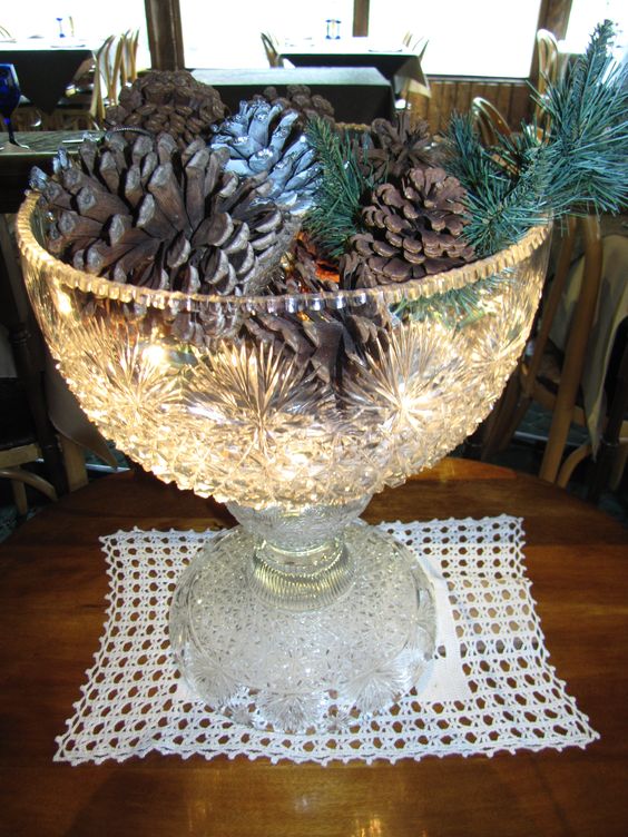 punch bowl filled with pinecones and lights
