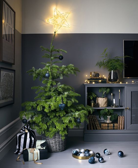 a modern tree in a basket and monochrome ornaments