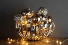 12 modern bowl filled with metallic ornaments and lights