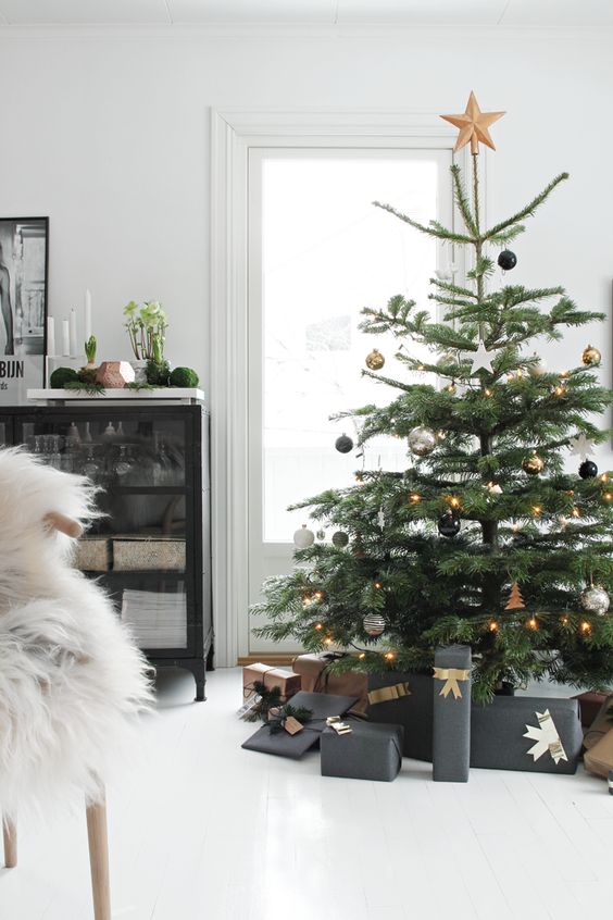a tree with black, white and gold decor looks modern and fresh