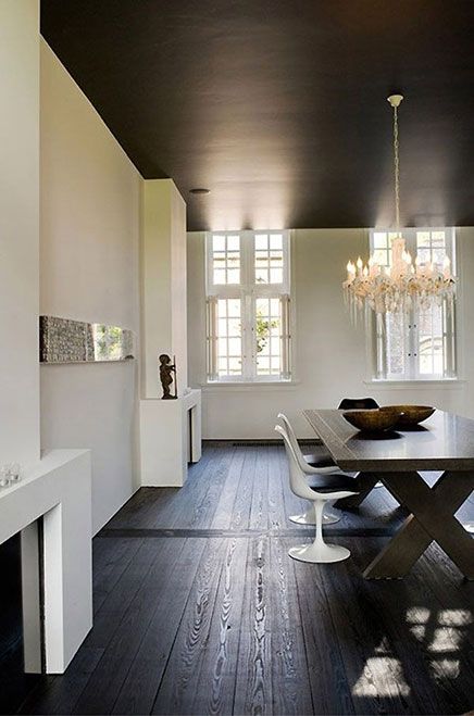 rustic stained dark picnic table contrasts with modern white chairs