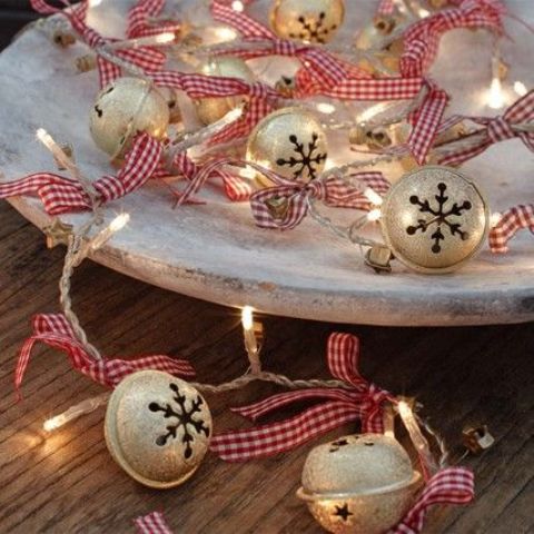 whitewashed tray with jingle bells and string lights