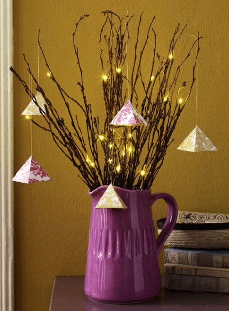 branches with geometric hangings and lights