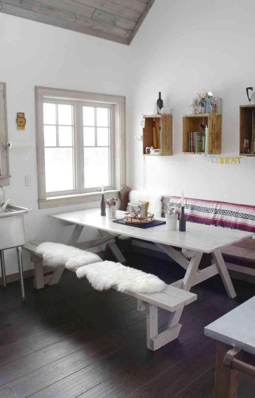 boho-styled picnic nook with a dining table and benches covered with fur