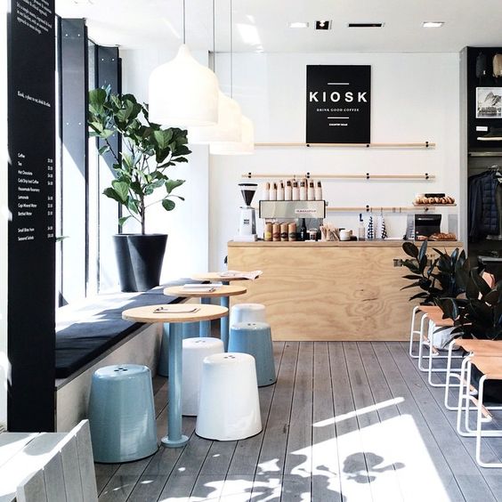 modern coffee shop with whitewashed floors, black accents and pastel touches
