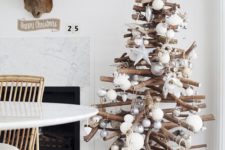 23 modern holiday tree of sticks with metallic and white ornaments
