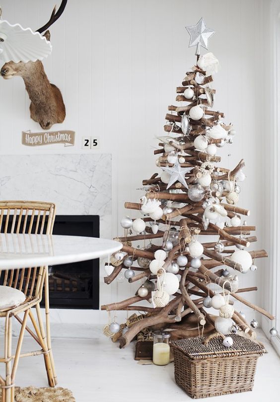 modern holiday tree of sticks with metallic and white ornaments