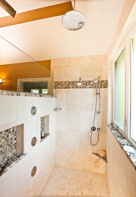 warm and light-colored walk-in shower with accentuated niches